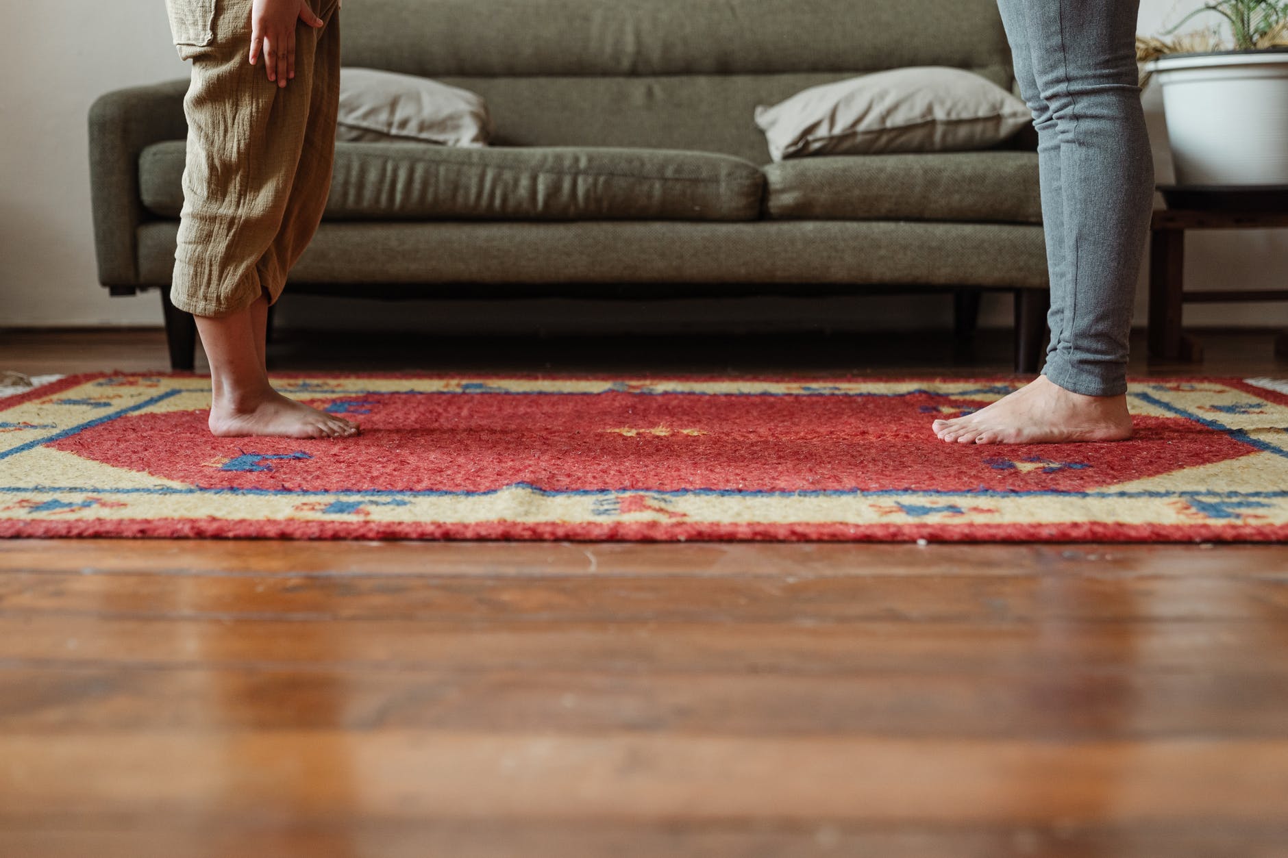 photo of two persons standing on carpet